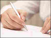 A student writes on a piece of paper
