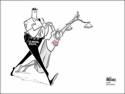A Capitol Hill policeman drags away a young female figure wearing a free speech t-shirt.