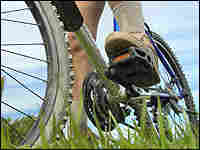 A foot on a bike pedal.