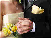 Prom couple holds hands.