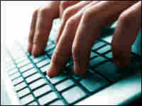 Fingers typing on laptop keyboard.