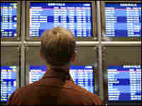 A passenger checks the Northwest Airlines Departures board at Detroit Metropolitan Airport.