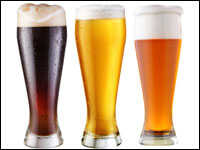 Three tall glasses of beer.